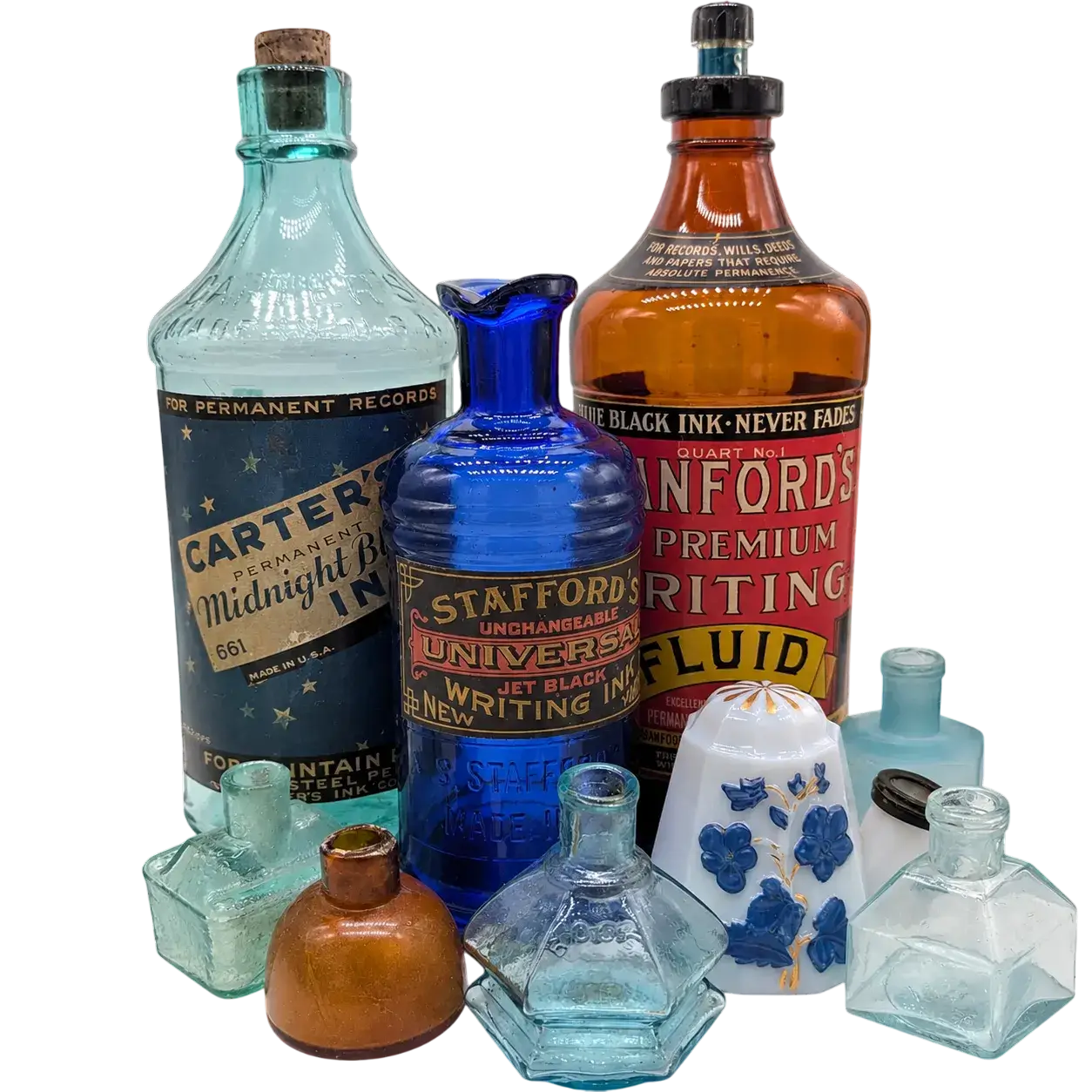 Nine Antique Ink Bottles of Various Shapes, Colors, Sizes, and Designs Arranged in a Group.