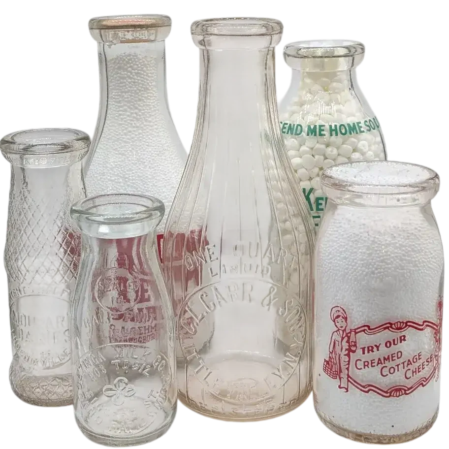 A Group of Six Antique Milk Bottles Arranged in a Cluster.